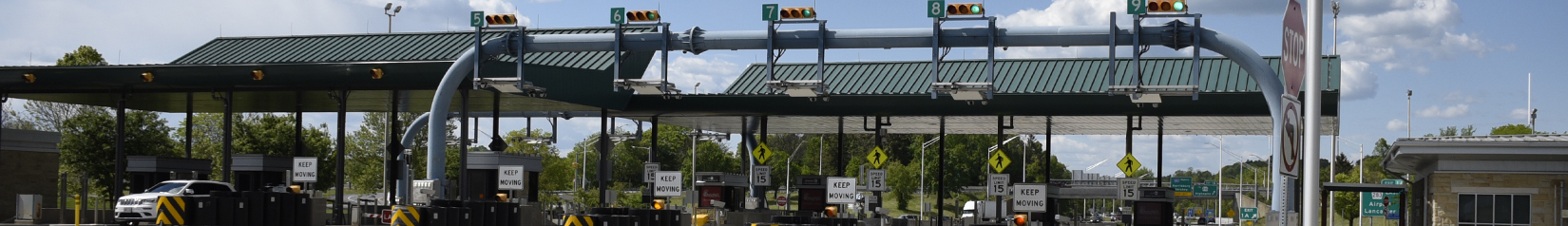 Banner image that shows a row of Pennsylvania Turnpike E-ZPass and cash toll booths